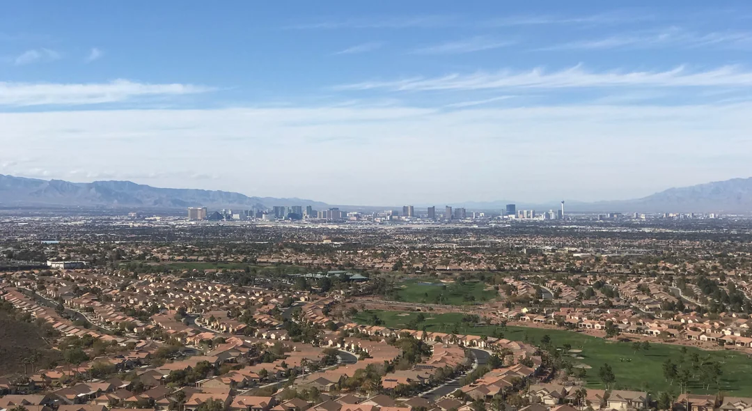 The Las Vegas valley looking toward the Strip, with master-planned neighbourhoods and a golf course in the foreground